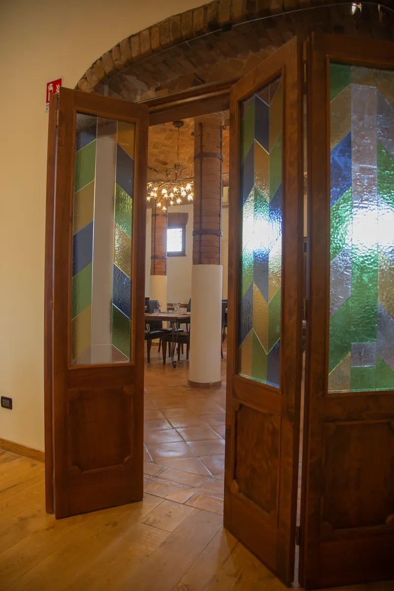 Le porte a vetri colorati che si aprono sulla sala delle colonne