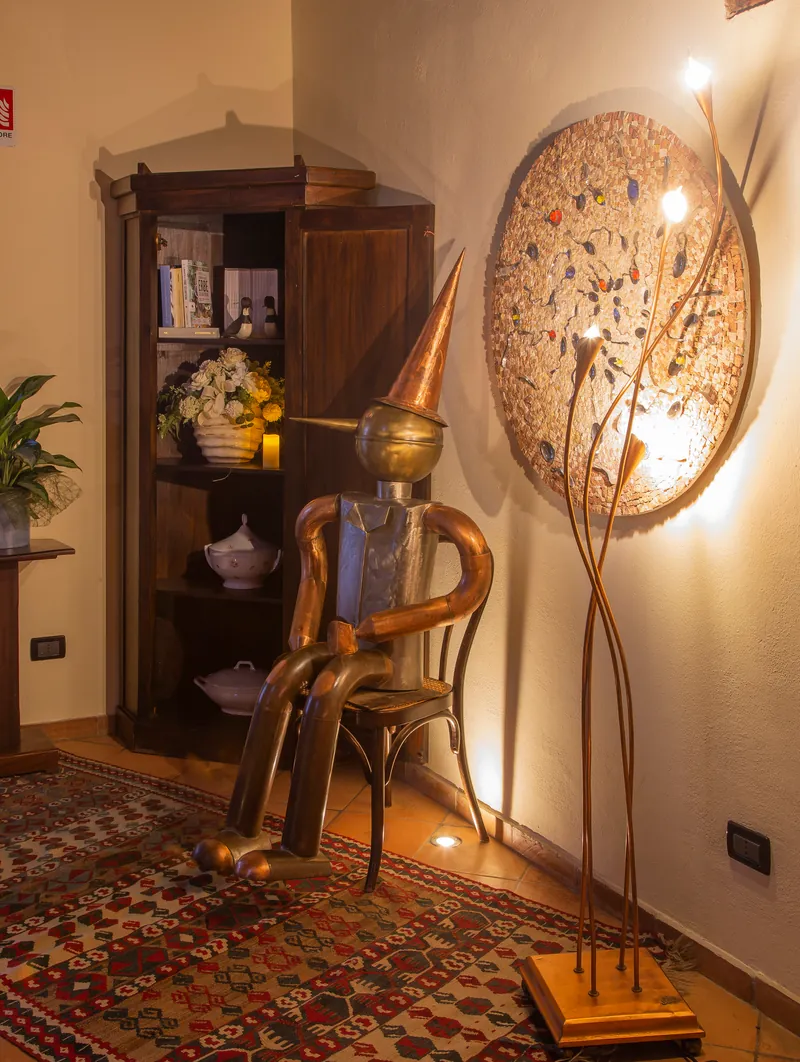 La statua in latta di un artigiano locale, fatta con materiali riciclati, alla destra dell'ingresso