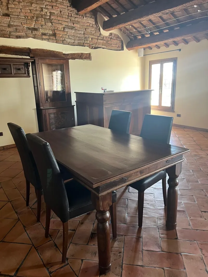 Tavolo in legno massello tra mattoni e travi